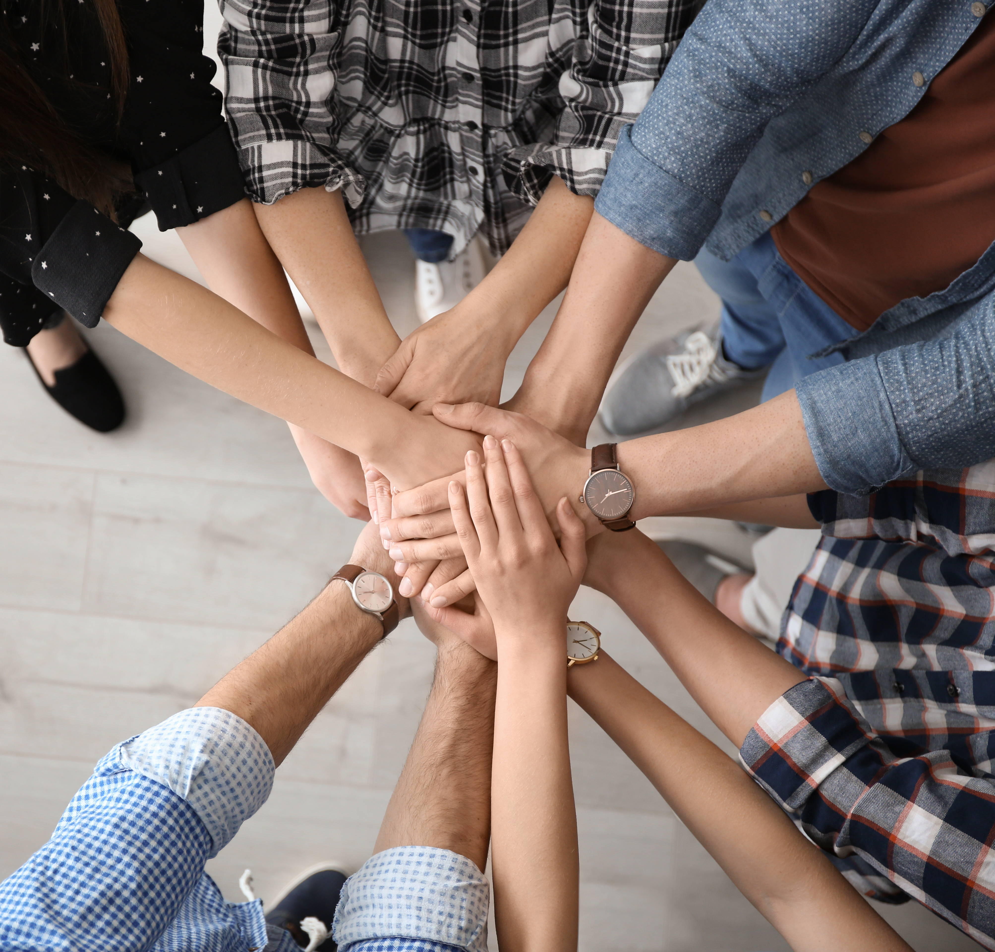 Hands all joined on top of each other, showing solidarity.